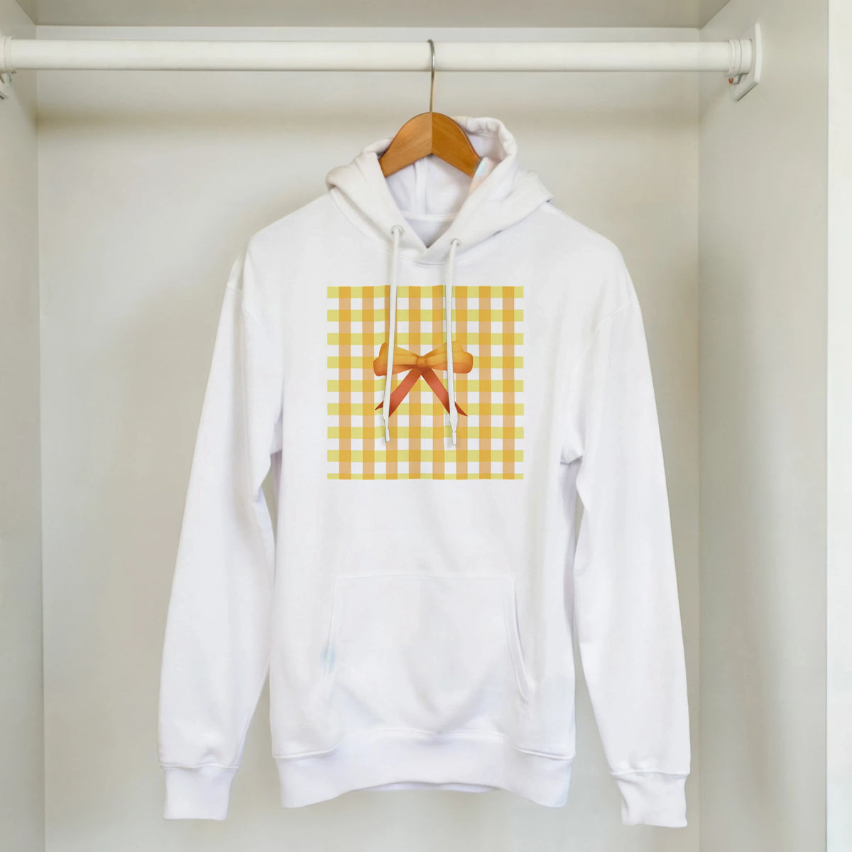 Cute Yellow Bow Gingham Hoodie on a hanger; white hoodie with yellow plaid bow graphic.