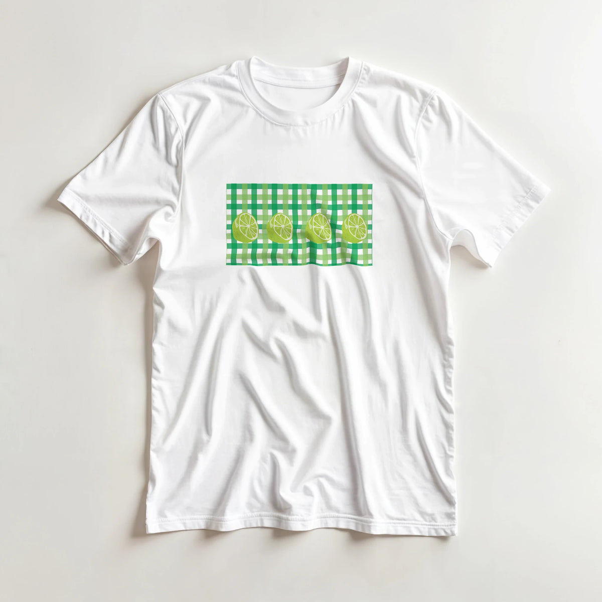 White women's t-shirt with a green gingham square and lime slices graphic.