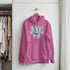 Pink Washington University women's cotton-blend hoodie with blue and white logo, front pocket, on hanger.