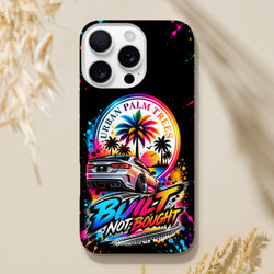 Built Not Bought iPhone case featuring a modified car, colorful Urban Palm Trees sunset graphic, and vibrant paint splatter art on a black background.