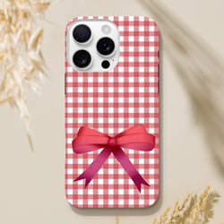 Red gingham iPhone case with a pink bow, featuring a cute coquette aesthetic and tough protection for iOS 13-16.