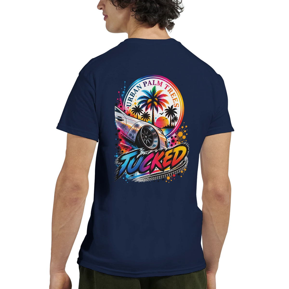 Back of navy T-shirt featuring colorful Tucked car graphic with Urban Palm Trees sunset and stylized tire tread text.