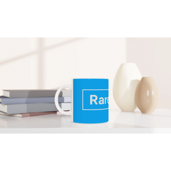 Blue Cute Rare Find mug on a desk with books, displaying the Rare Find slogan.