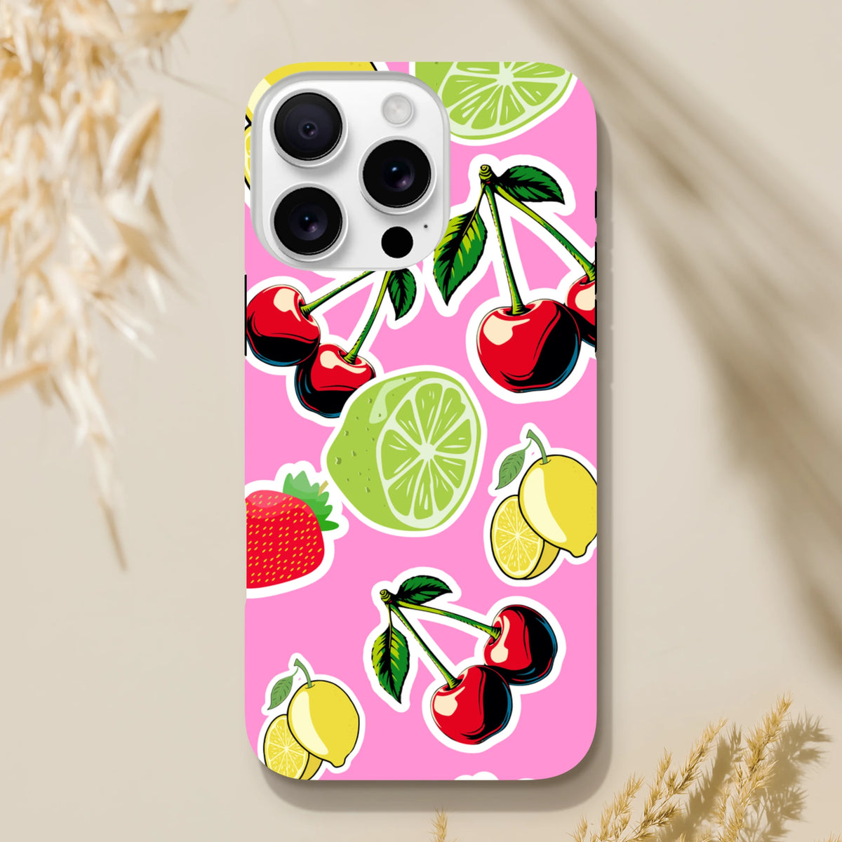 Pink iPhone case featuring cherry, lime, and lemon sticker art on a vibrant background. Tough, shock-absorbing protective cover.