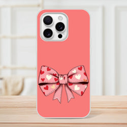 Pink iPhone case with a large heart-patterned bow on the back for iPhone 13–16, camera cutout visible.
