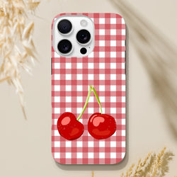 Red checkered gingham iPhone case featuring glossy two cherries, designed as a tough protective cover for iPhone 13-16 series.