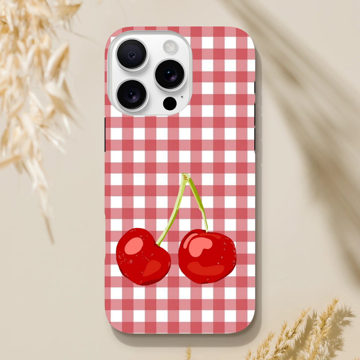 Red checkered gingham iPhone case featuring glossy two cherries, designed as a tough protective cover for iPhone 13-16 series.