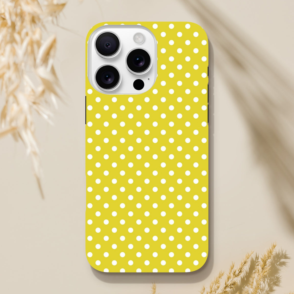 Yellow and white polka dot tough iPhone case compatible with iPhone 13-16 models, featuring cute vintage styling and impact-absorbing TPU protection.