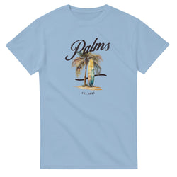 Light blue women's tee featuring a palm tree, surfboard graphic, Palms script, and EST. 1985.