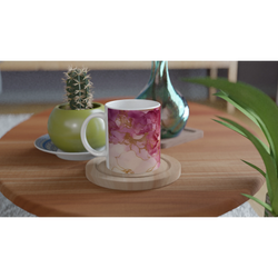 Pink marble mug with blush rose gold abstract pattern on a wooden table beside green plants.