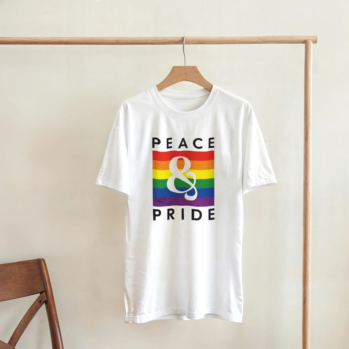 White women's Pride T-shirt, soft cotton blend, rainbow flag graphic and Peace & Pride lettering.