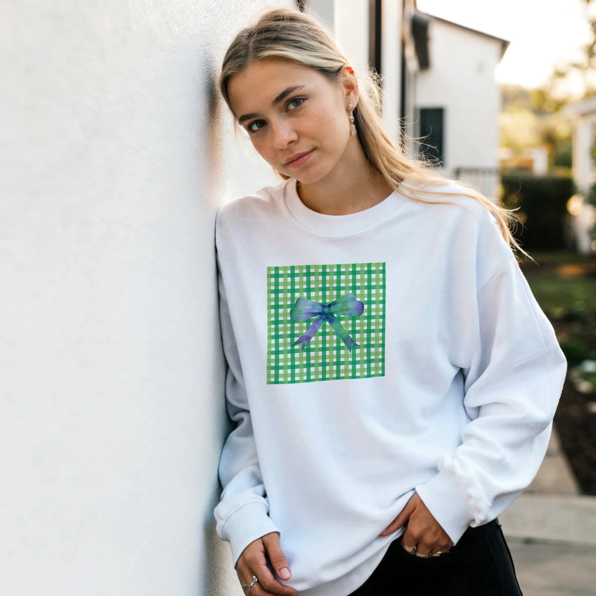 White pullover sweatshirt featuring a green gingham square print with a purple bow for a cute coquette aesthetic.