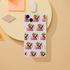 Slim transparent iPhone case for iPhone 13–16 with a repeating colorful dog wearing sunglasses pattern.