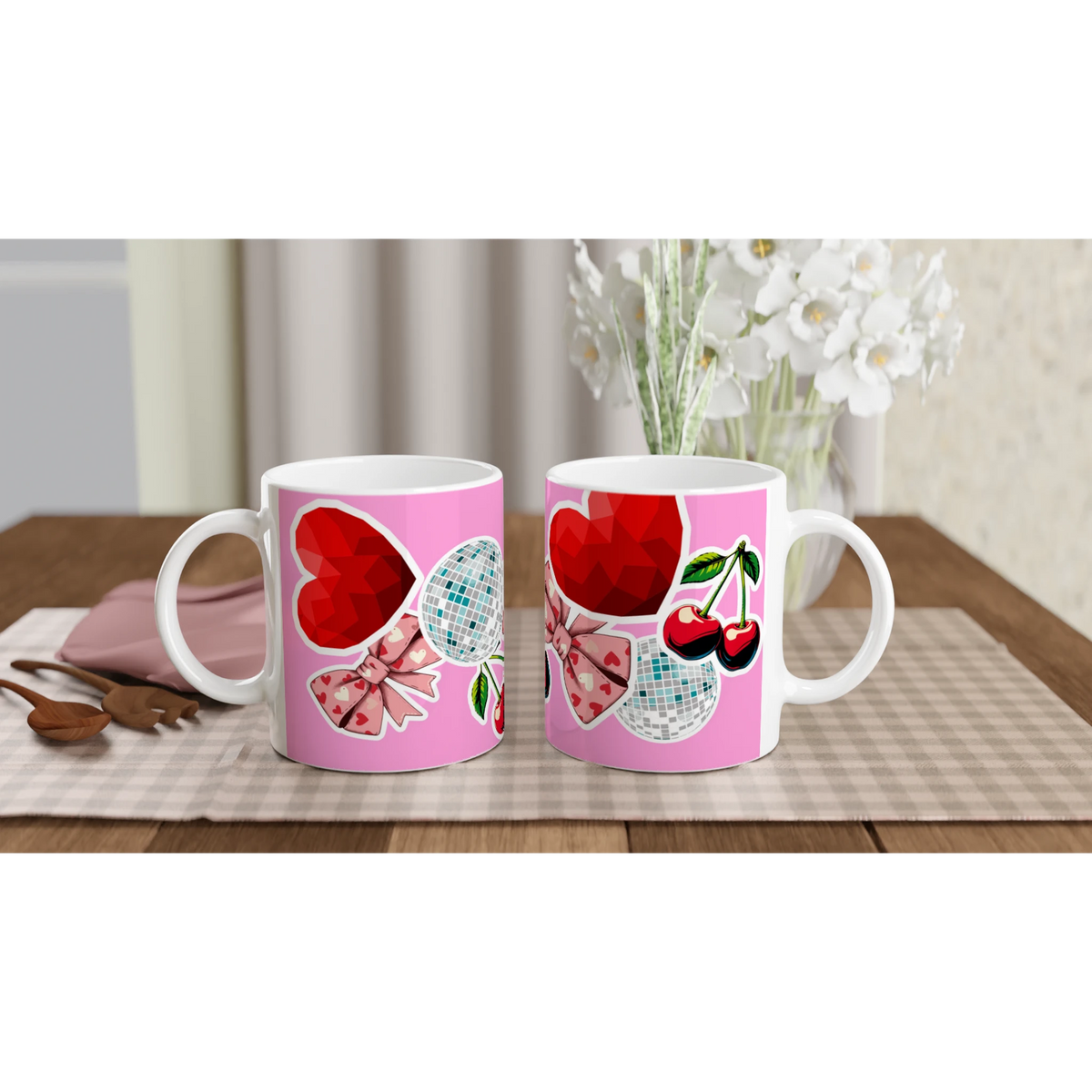 Cute coquette ceramic mug featuring pink bows, red hearts, cherries, and disco balls on a wooden desk.