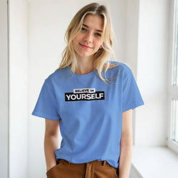 Young woman wearing a blue Believe In Yourself T-shirt with retro slogan.