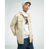 Male model wearing a white Trance Gorilla graphic hoodie under a beige overshirt with blue jeans