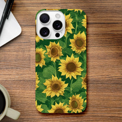 Sunflower Tough iPhone Case featuring a bold floral wraparound print with yellow blooms and green leaves on a wooden desk.