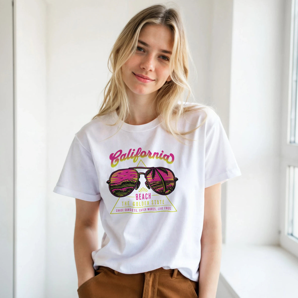 Woman wearing Y2K California Beach T-Shirt for Women, retro aesthetic top with pink sunglasses and palm-tree graphic.