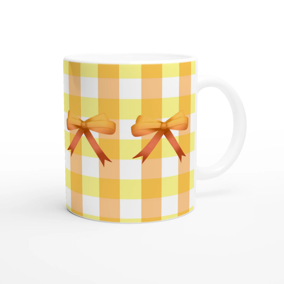 Yellow gingham bow mug with orange ribbon bows, a cute coquette coffee cup.