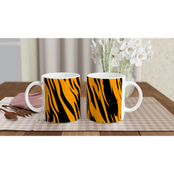 Two orange and black tiger-print mugs on a table, bold animal-print coffee cups.