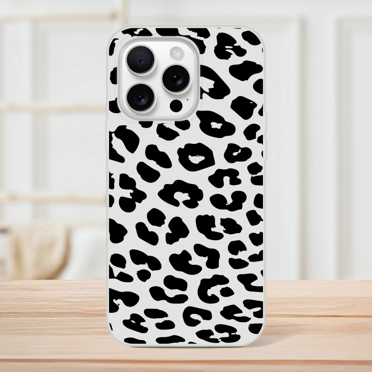 Retro snow leopard print iPhone case for 13–16 with bold black-and-white animal pattern.