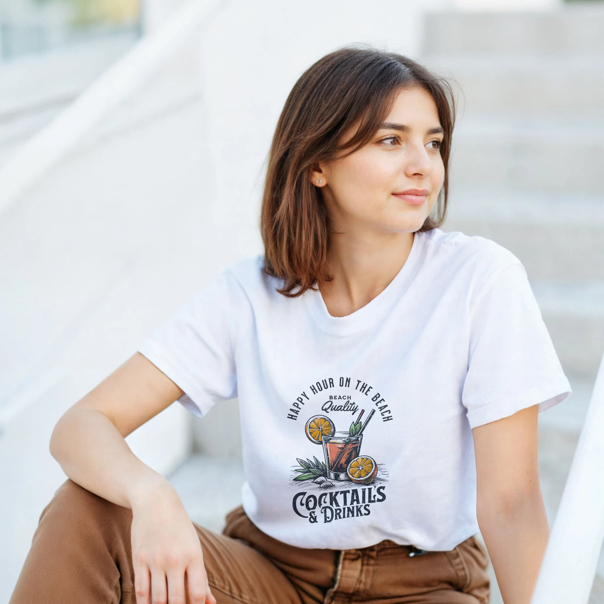Woman in white cotton-blend Happy Hour T-shirt with tropical cocktails illustration.
