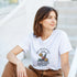Woman in white cotton-blend Happy Hour T-shirt with tropical cocktails illustration.