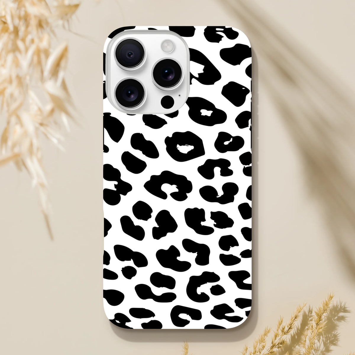 Black and white snow leopard print tough iPhone case providing shock-absorbing protection with a seamless wrap-around design.