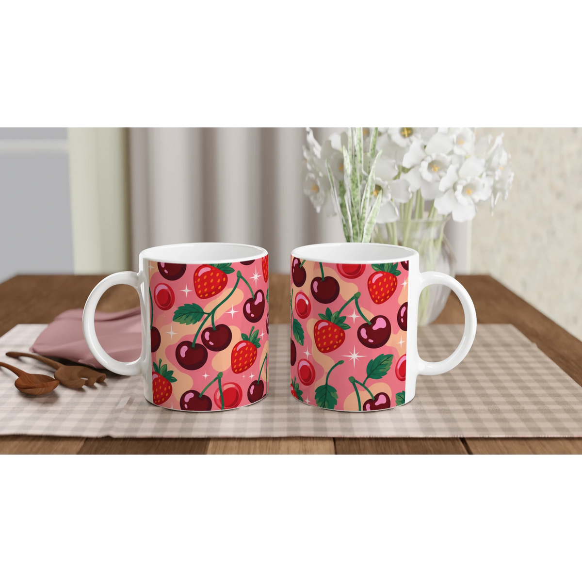 Two cherry and strawberry ceramic mugs with a cute retro fruit pattern on pink background.