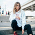 Woman in light-blue soft cotton-blend women's cherries hoodie in an urban setting.