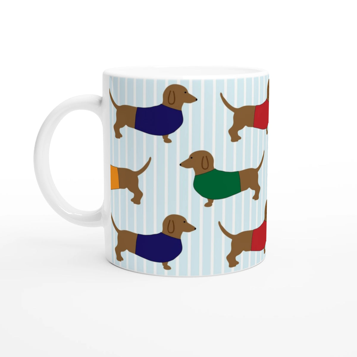 Sausage dog ceramic mug with dachshund pattern and colorful sweaters on a light blue striped background.