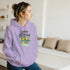 Woman in lavender Lemon Quencher graphic hoodie with lemon plant design.