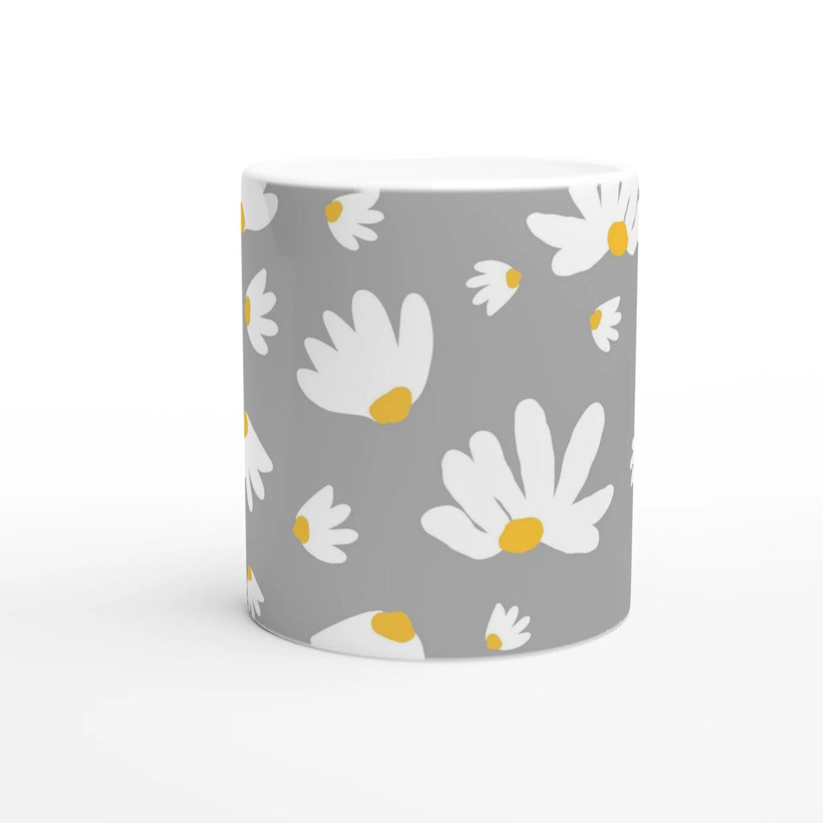 Ditsy Daisy Mug with white daisies and yellow centers on a gray background.