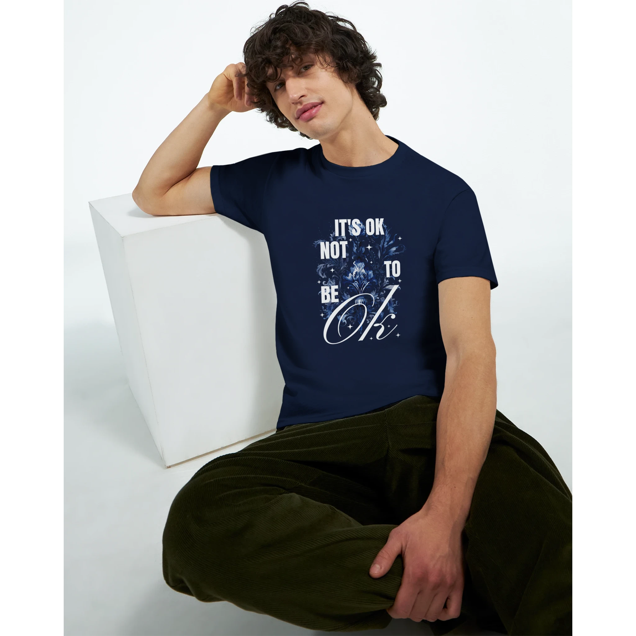 Male model wearing navy cotton-blend Slogan T Shirt with It's OK Not To Be OK graphic.