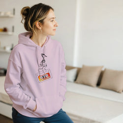 Lavender women's hoodie featuring a retro cassette tape graphic with unspooled black tape and vintage 90s hits label detail.