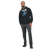 Man wearing a black Men's Wanted Teddy Bear Hoodie with a blue teddy graphic and bold WANTED lettering.
