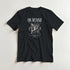 Outcast men's black graphic T-shirt featuring white gothic art and a winged figure beneath the OUTCAST text.