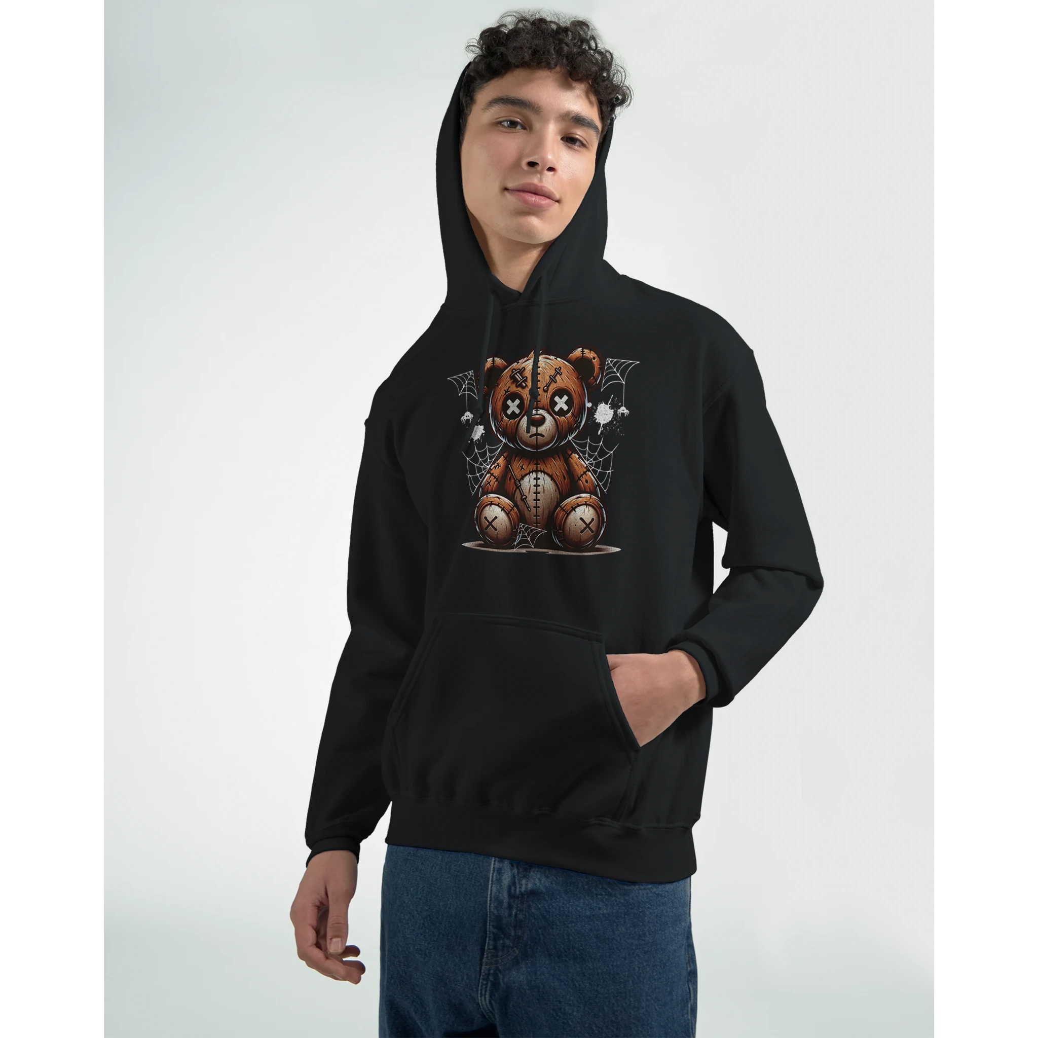 Male model wearing black hoodie with stressed teddy bear graphic and spiderweb backdrop.