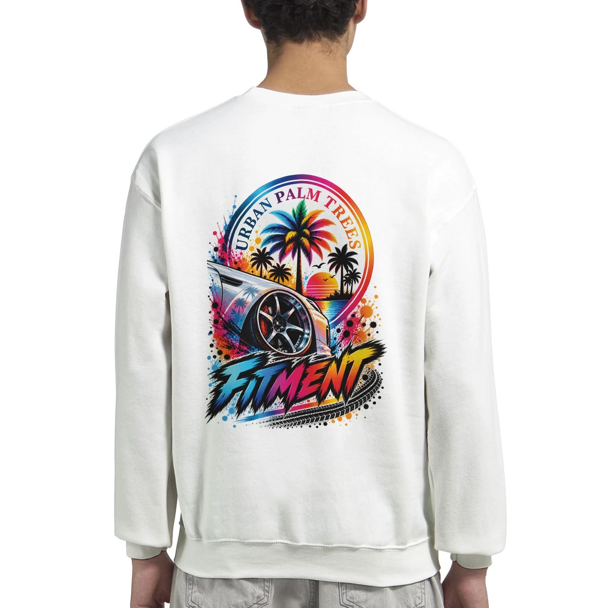 White sweatshirt back featuring colorful "Urban Palm Trees" and "Fitment" graphic with modified car and sunset design.