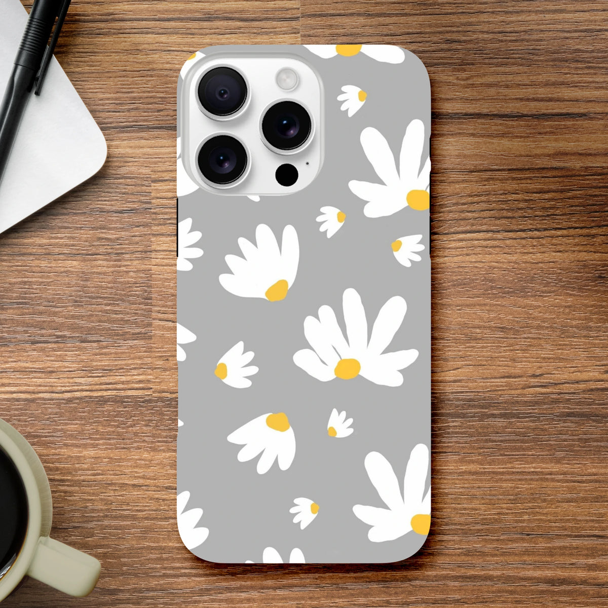 Grey protective iPhone case featuring a white daisy floral pattern with yellow centers on a utilitarian grey background.