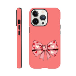 Pink tough iPhone case featuring a cute coquette bow with a red and white heart pattern for bold street-style aesthetics.