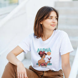 Woman wearing white Aloha graphic T-shirt with tropical cocktail print.