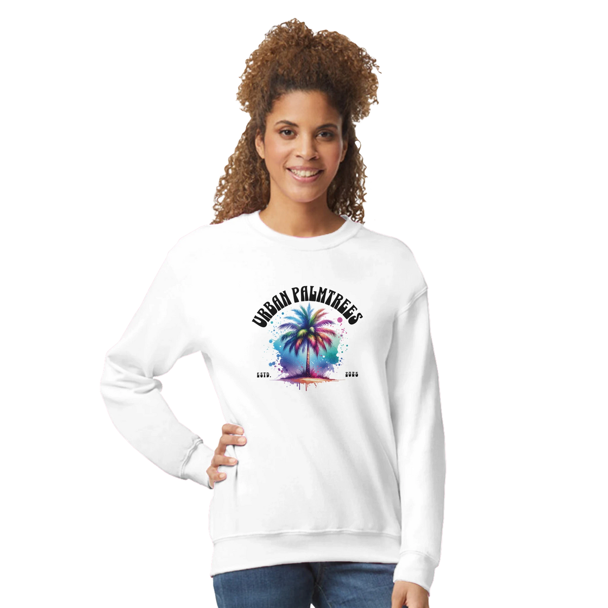 Smiling woman wearing a white Urban Palm Trees Sweatshirt with pastel palm tree graphic.