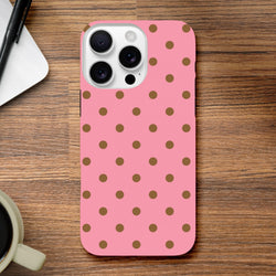 Pink & Brown Polka Dot iPhone Case with shock-absorbing TPU and glossy finish for models 13-16. Cute protective phone cover on wood desk.