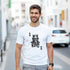 Smiling man wearing a white King graphic T-shirt with a crowned skull design.