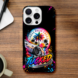 Tucked Petrolhead iPhone case featuring modified car, urban palm trees sunset, and colorful paint splatter on black background.