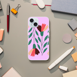 Pink floral iPhone case for iPhone 13-16 with green leaves and vintage aesthetic on a desk.