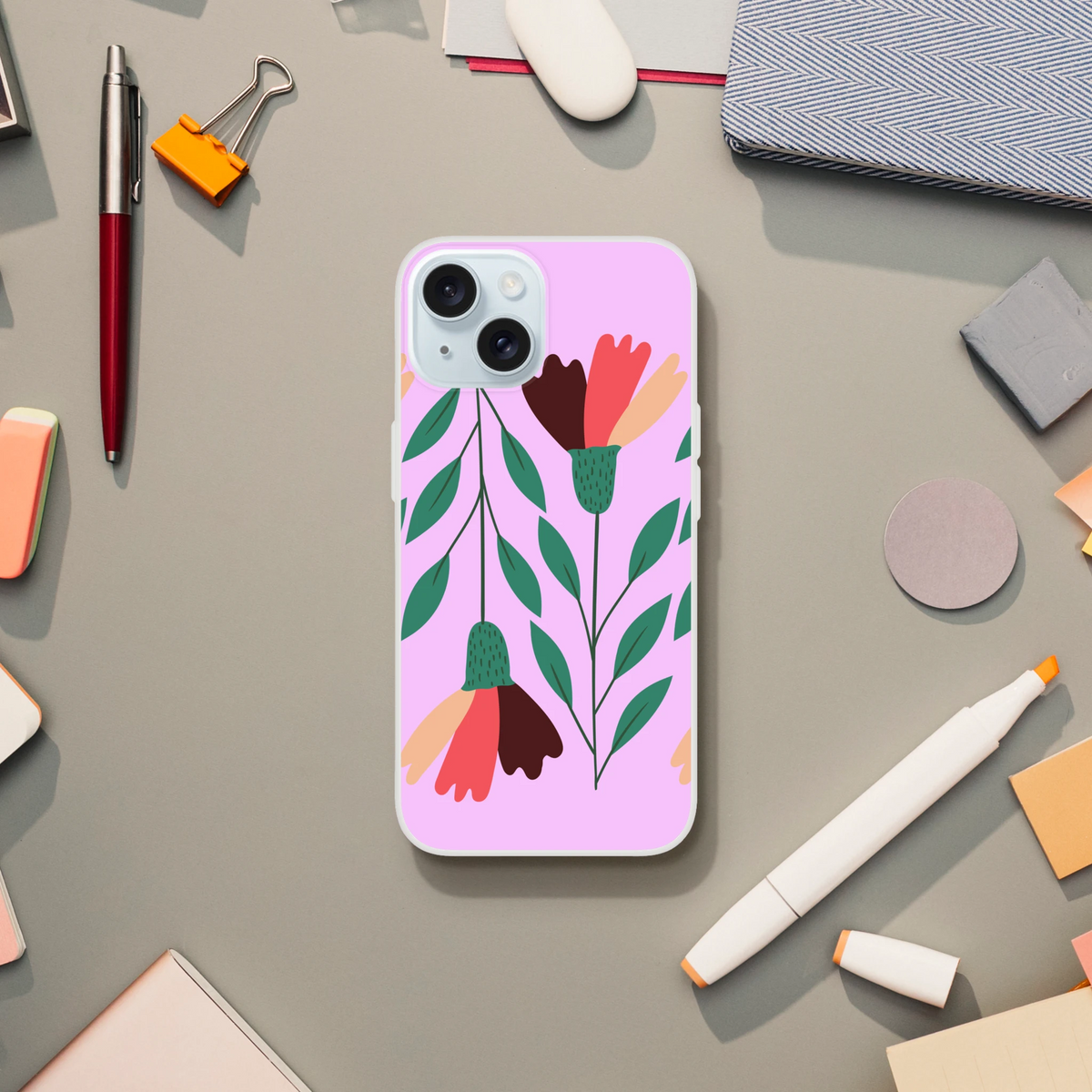Pink floral iPhone case for iPhone 13-16 with green leaves and vintage aesthetic on a desk.