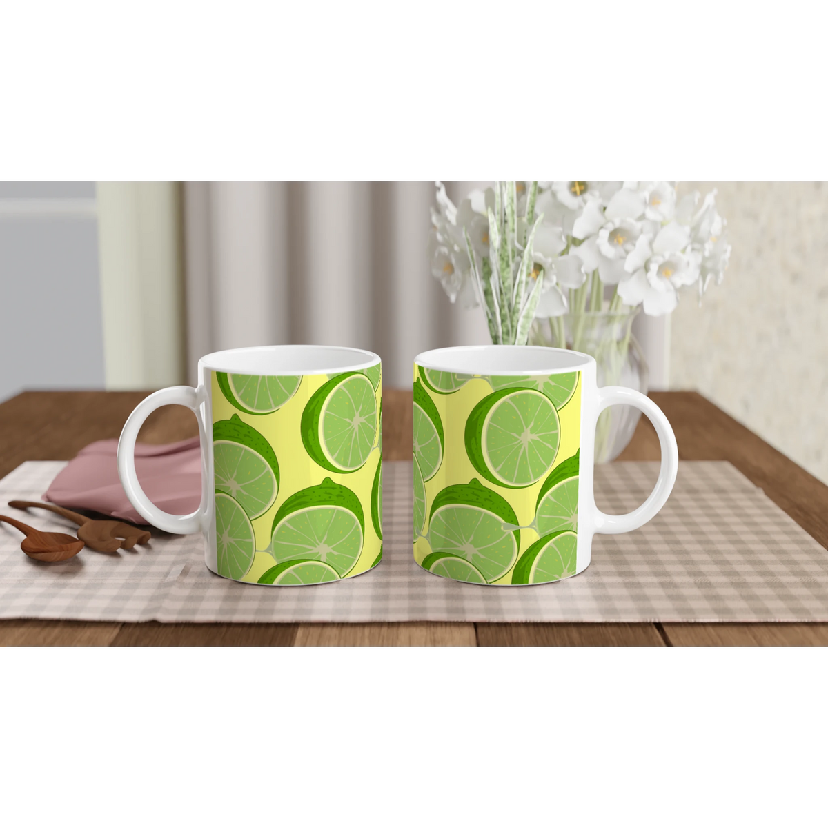 Two lime-slice patterned ceramic mugs with bright citrus design on a wooden table.