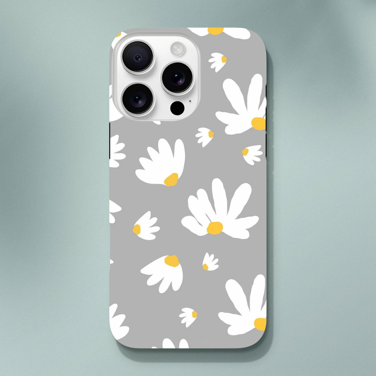 Grey iPhone case featuring a white daisy floral pattern with yellow centers on a utilitarian grey background.